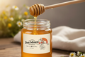 Dos Manos logo expanded within square cream label on honey jar